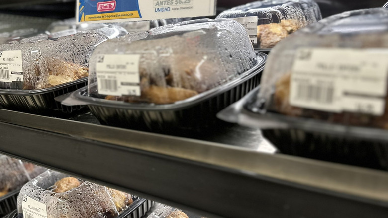 Rotisserie chicken in a plastic container with condensation