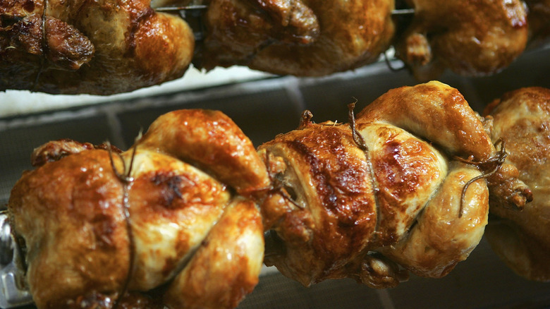 Rotisserie chickens being cooked