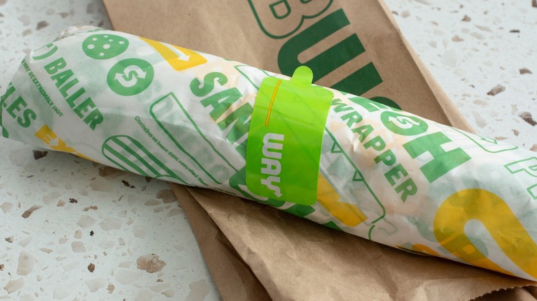 Footlong sandwich from Subway wrapped and atop bag