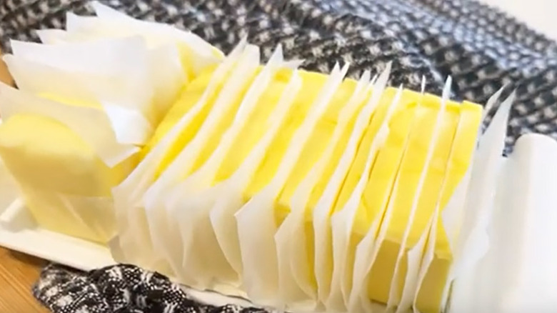 Sliced butter on wooden board