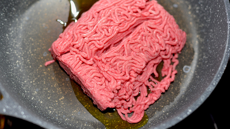 Pan with raw ground beef