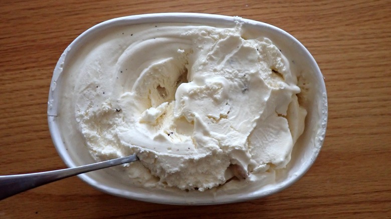 A carton of cookie dough ice cream with a spoon in it