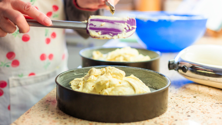 person putting batter into pan