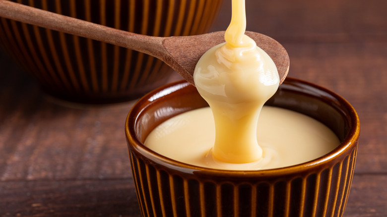 canned condensed milk on spoon