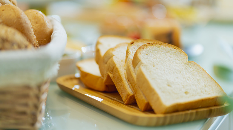 Sliced bread on wooden tray