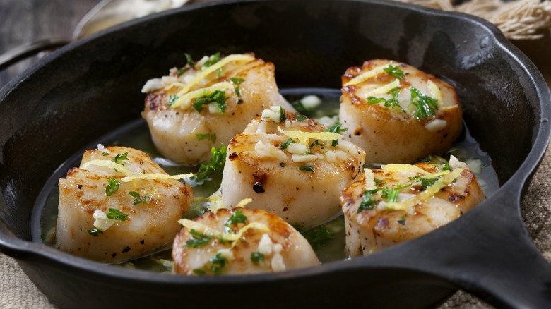 Scallops in cast iron pan with seasonings