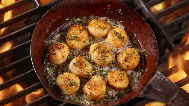 Scallops searing in cast iron pan