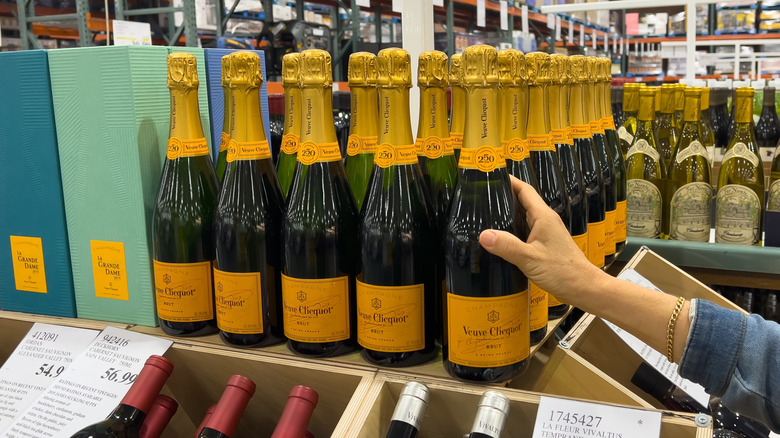 Hand reaching for Champagne in Costco store