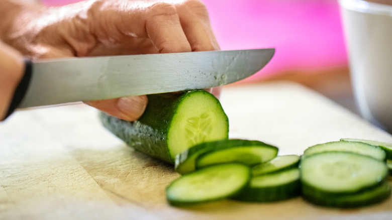 Close-up of knife and cucumber slices