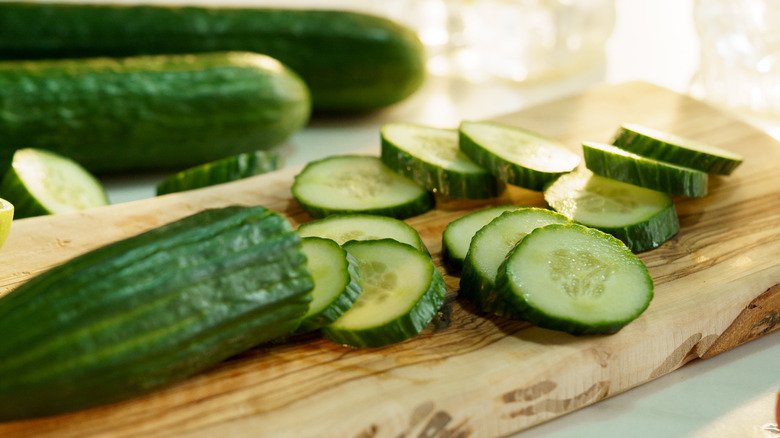 Sliced cucumber on a wooden cutting board