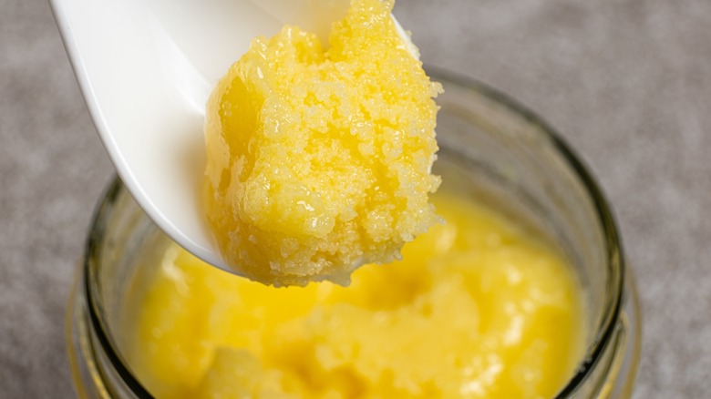 Clarified butter on a white spoon