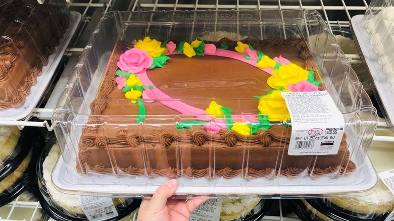 A sheet cake with pink and yellow roses