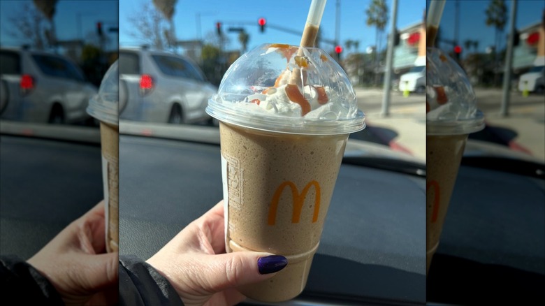 Hand holding a McDonald's Caramel Frappé 