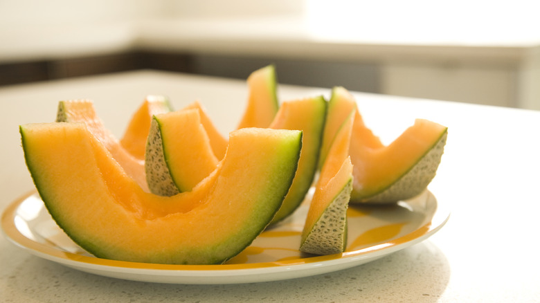 Plate of canteloupe slices on countertop