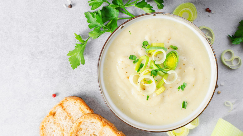 Bowl of creamy soup with green herbs