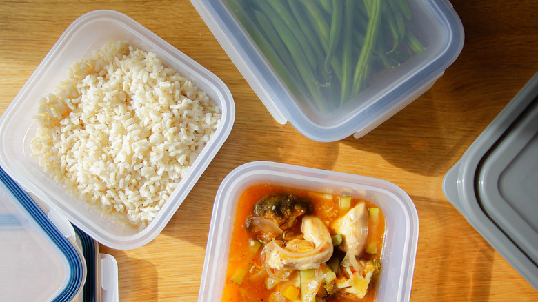 rice and other foods in a plastic leftover container