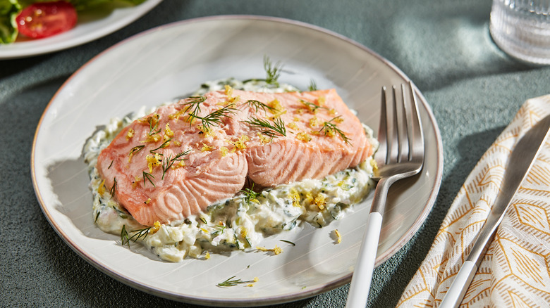 poached salmon on plate with fork