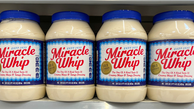 Jars of Miracle Whip on a shelf in a grocery store