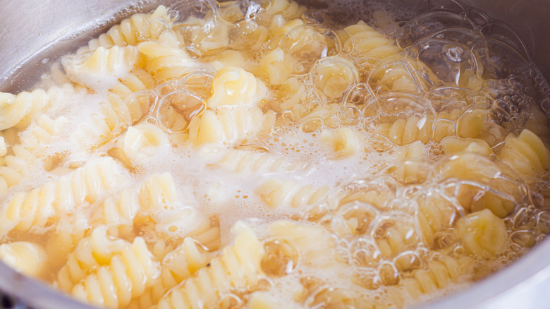 Pot of boiling spiral pasta