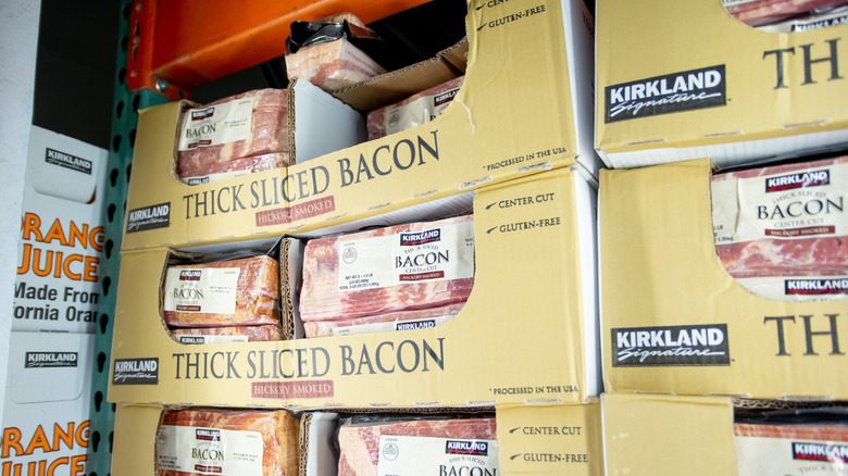 Boxes of packages of thick-sliced Kirkland Signature hickory-smoked bacon