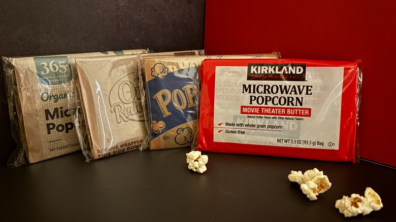 Microwave popcorn packets with popcorn kernels in front