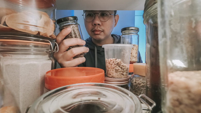 smiling man looking at grocery list