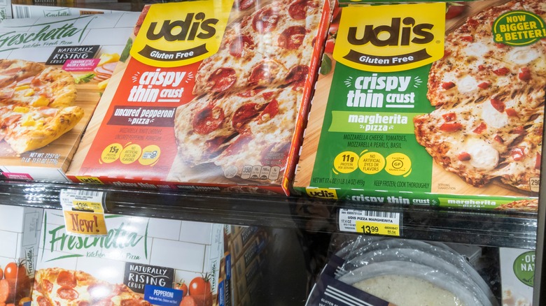 gluten free pizza in glass case at grocery store