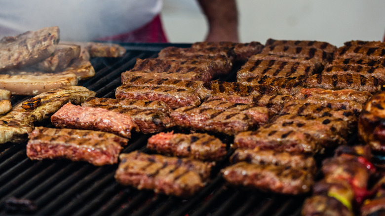 Crowded grill loaded with meat