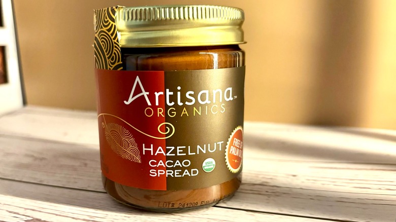 Artisana Organics Hazelnut Cacao Spread jar on table