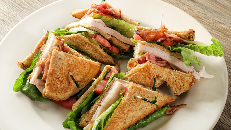 club sandwich on a plate with toothpicks sticking out