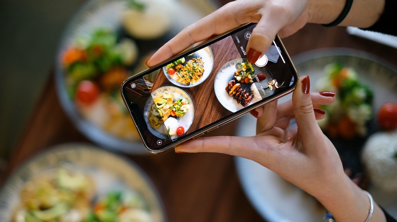 Person taking a photo of food with a cellphone