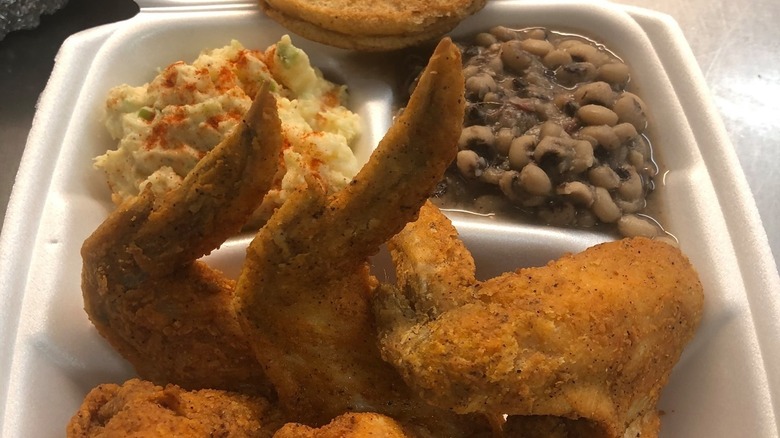 Plate of fried chicken, black-eyed peas, and potato salad