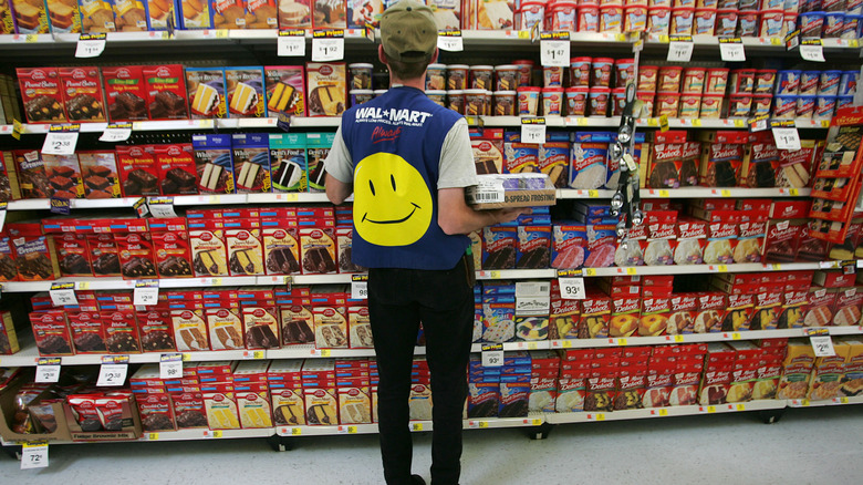 Walmart employee stocking grocery shelves