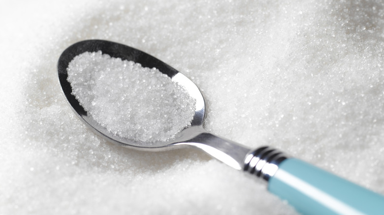 A spoonful of white granulated sugar