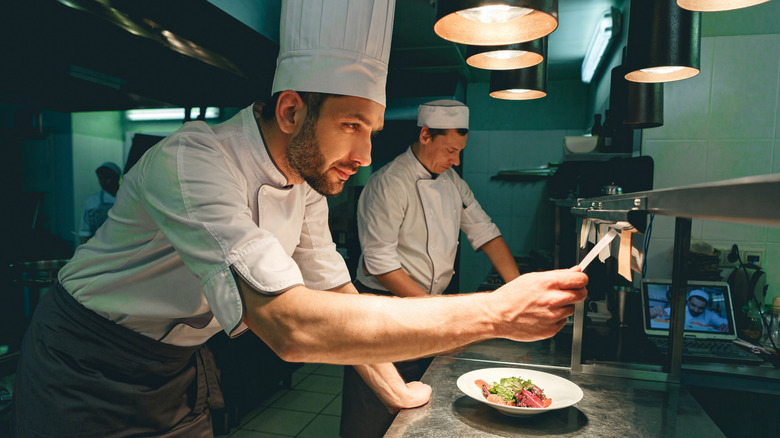 Chef checking orders in a restaurant kitchen