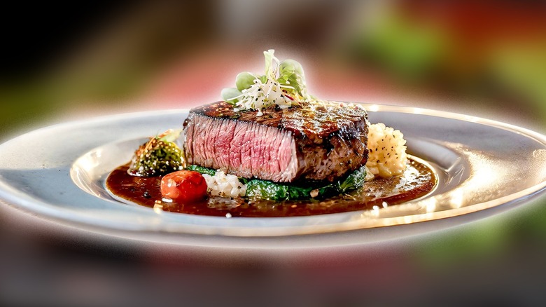 Plated rare steak on restaurant table