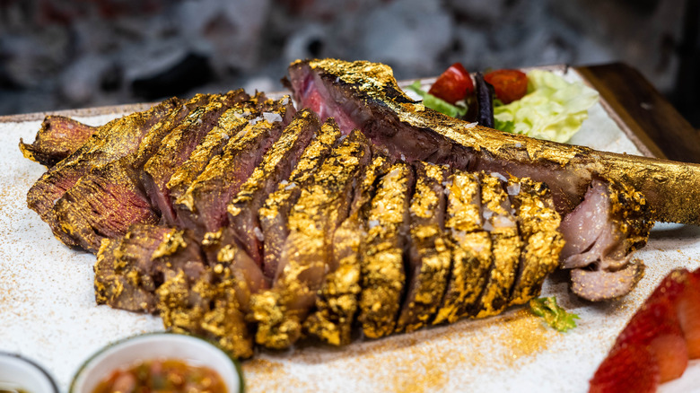 Sliced steak coated in gold leaf