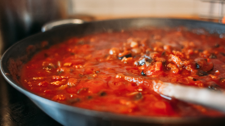 Tomato sauce and spoon in pan