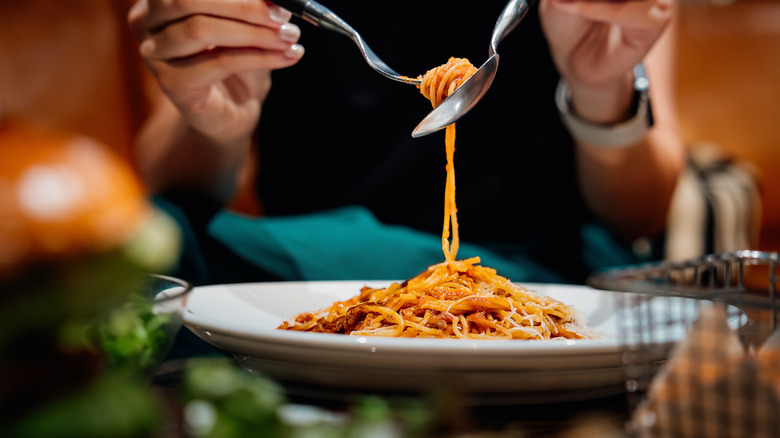 Person twirling spaghetti on fork