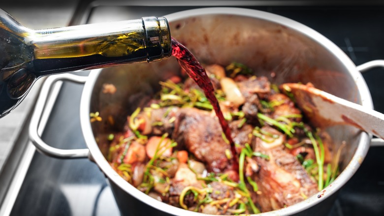 Pouring red wine into a pot