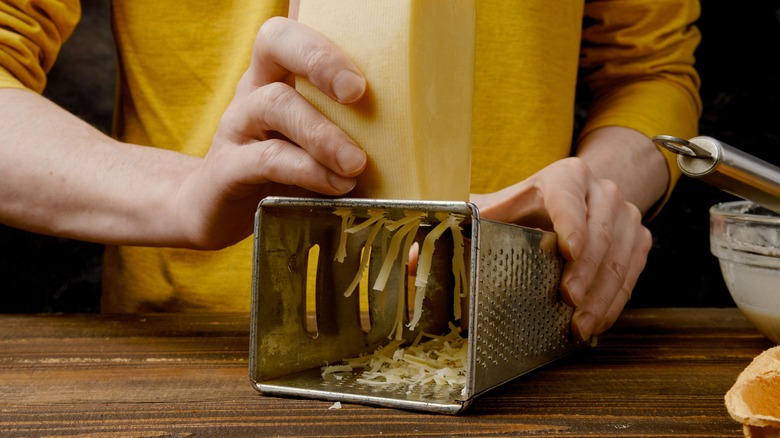 horizontal box grater shredding cheese