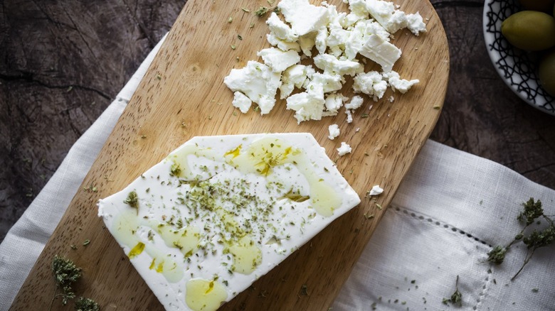 crumbled feta on cutting board