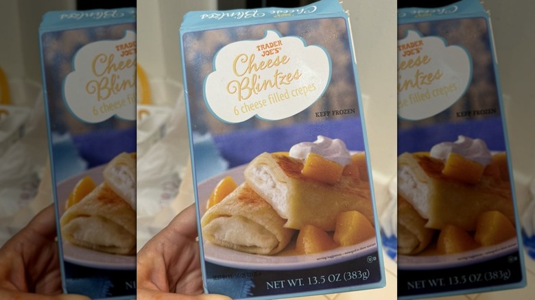 Hand holding Trader Joe's Cheese Blintzes package