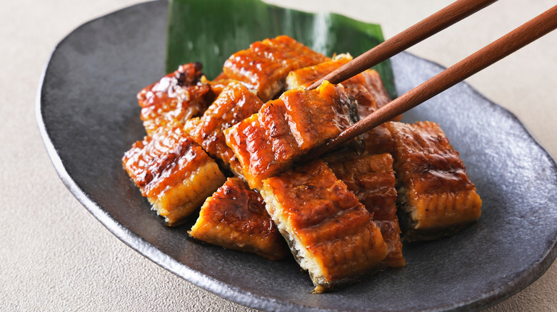 Chopsticks picking up cooked eel