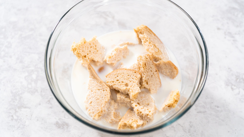 Pieces of bread soaking in milk