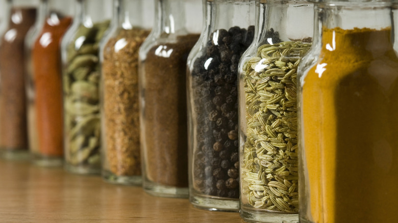 Row of spices and seasonings in glass jars