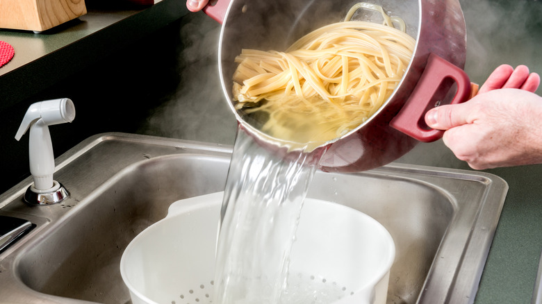 Draining pasta in colander