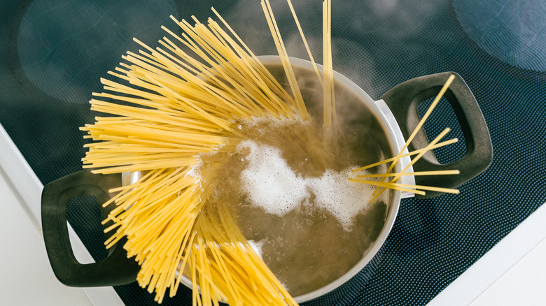 Cooking spaghetti in a pot of water