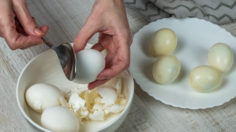 Woman peeling eggs