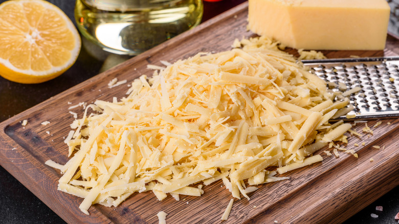 Shredded cheese on a wooden board